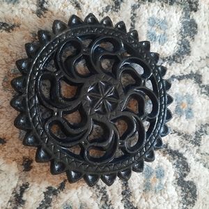 John Wright cast iron round trivet.